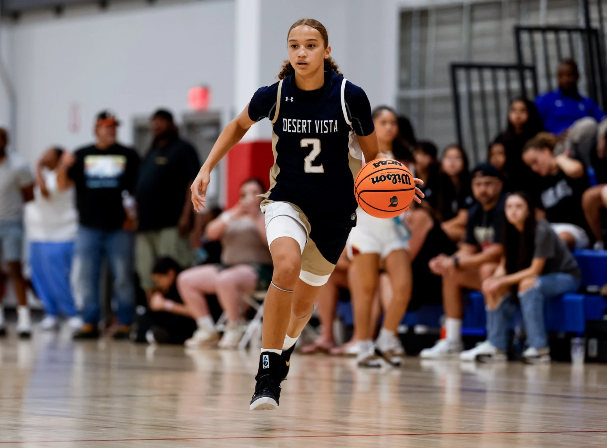 Girls basketball player advancing the ball