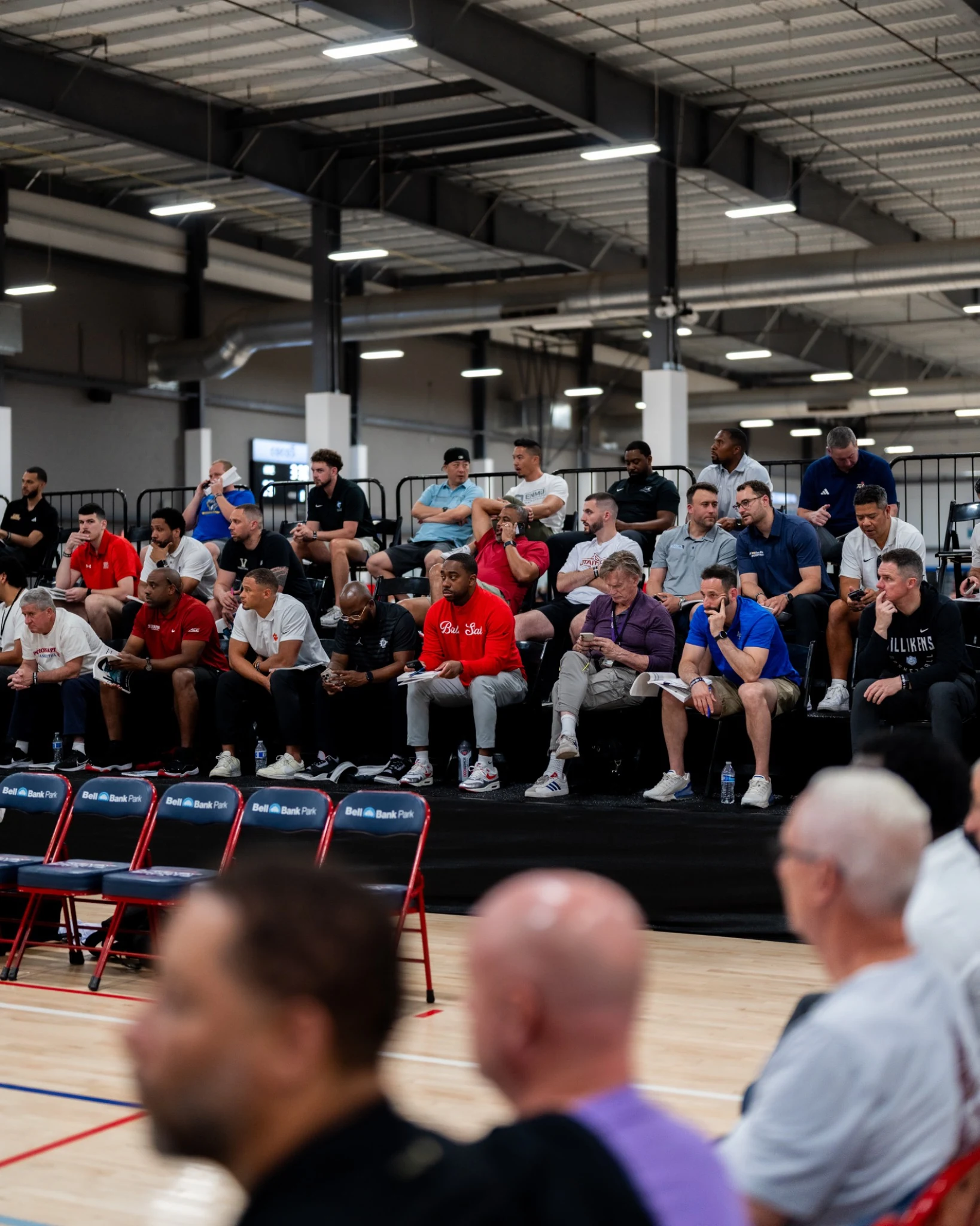 College coaches watching Section 7 basketball from courtside